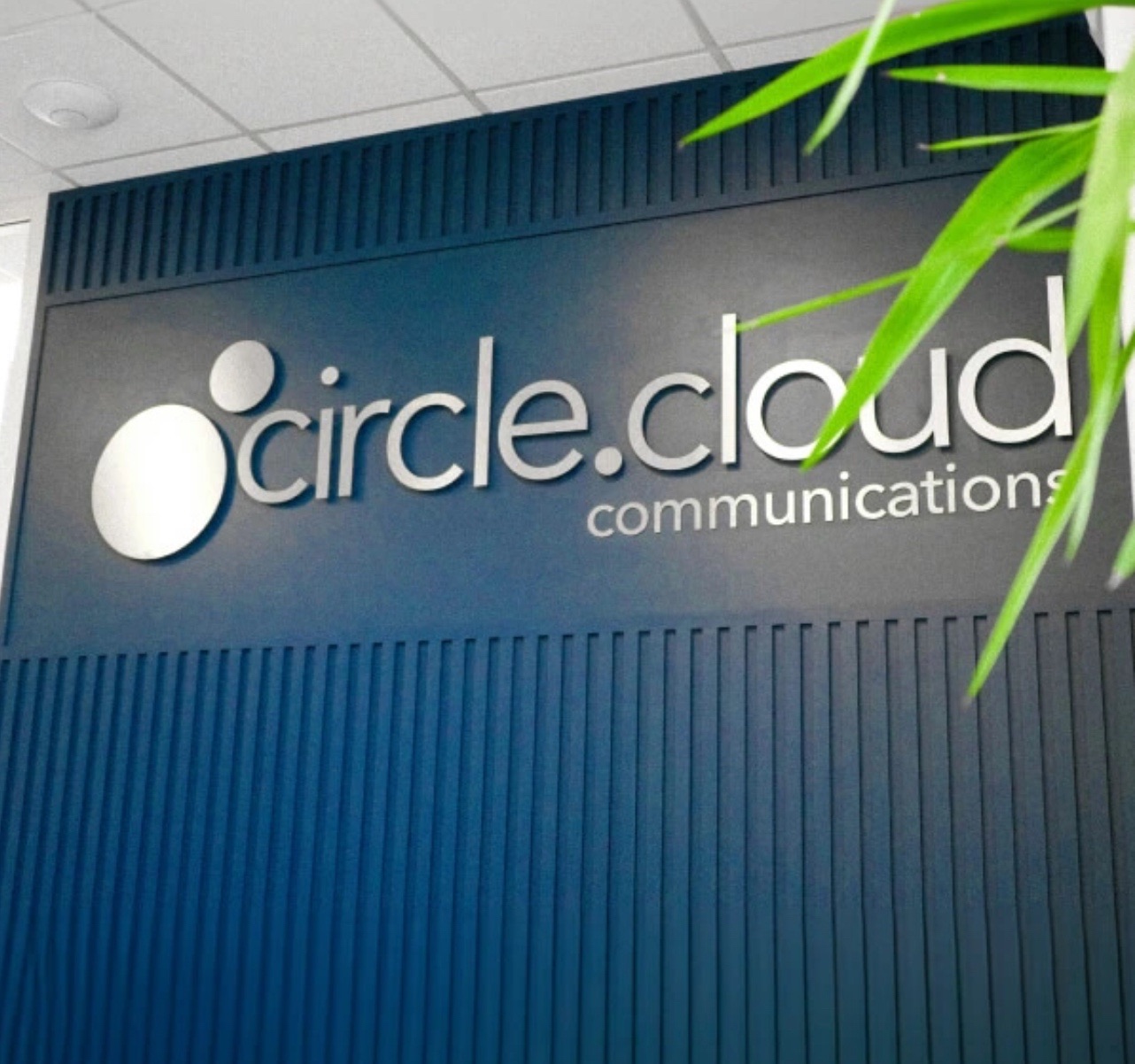 The circle.cloud communications sign on the wall of the current office